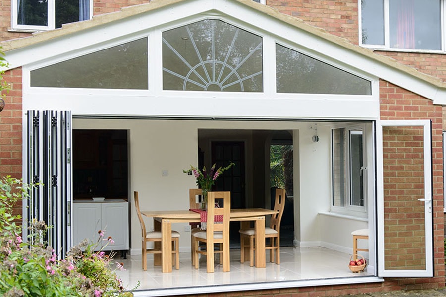Gable end house extension white aluminium bi fold doors