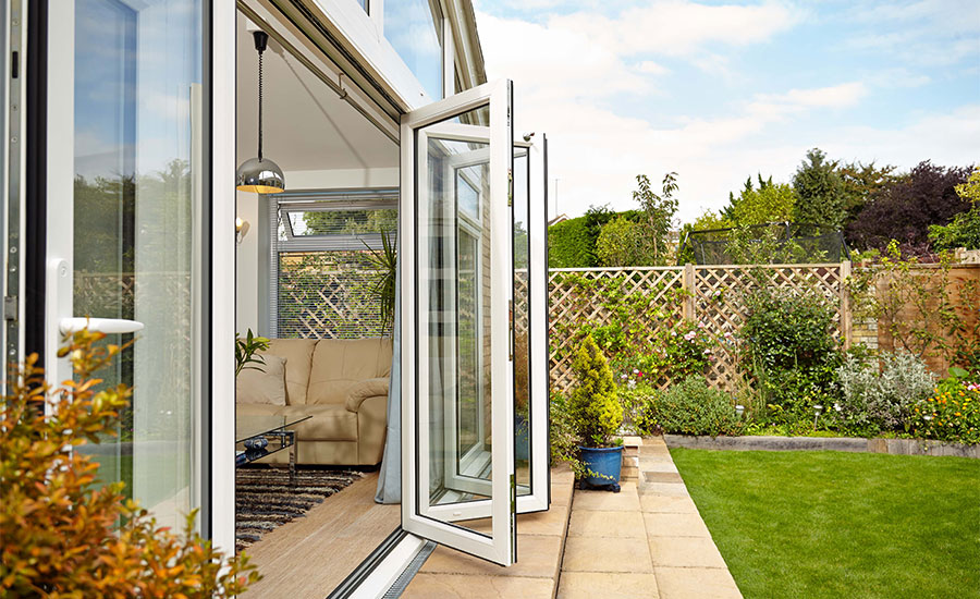 White aluminium bi fold doors Anglian extension side view
